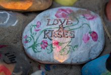 "love and kisses" written on a stone