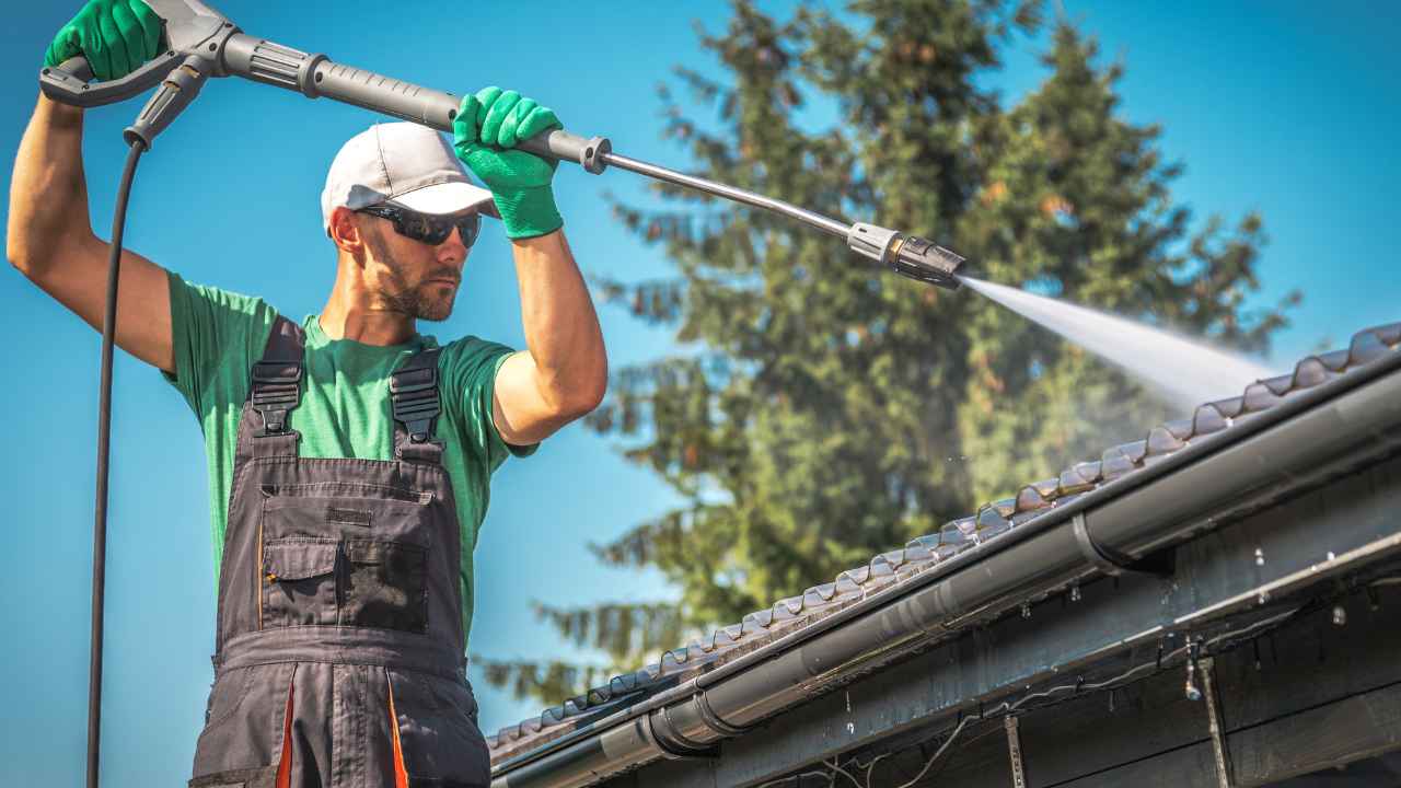 Guy cleaning roof